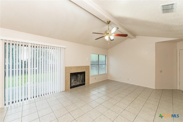 5111 Anacacho St, San Antonio, TX 78217 - unfurnished living room with ceiling fan, light tile patterned floors, a tile fireplace, and a textured ceiling