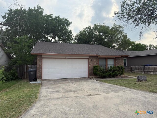 5111 Anacacho St, San Antonio, TX 78217 - view of front facade with brick siding, concrete driveway, and a garage
