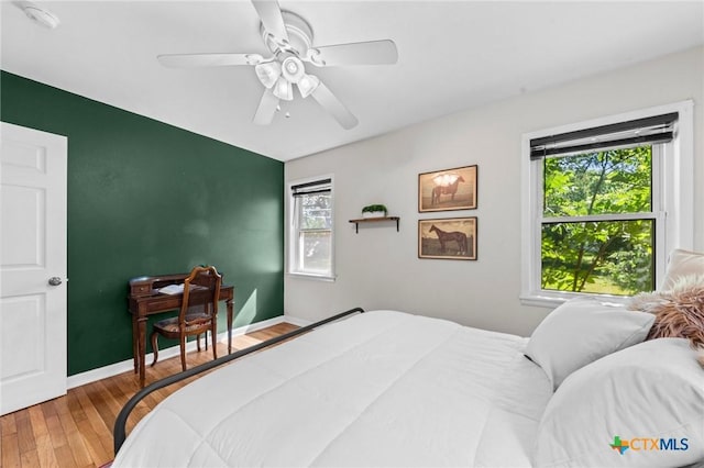 2105 S 49th St, Temple, TX 76504 - bedroom featuring wood finished floors, a ceiling fan, and baseboards