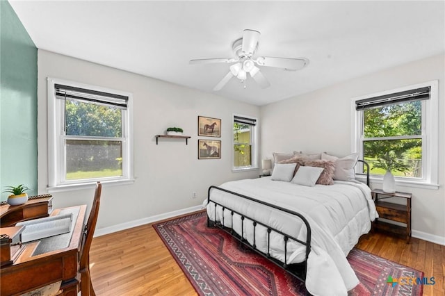 2105 S 49th St, Temple, TX 76504 - bedroom with wood finished floors, baseboards, and ceiling fan