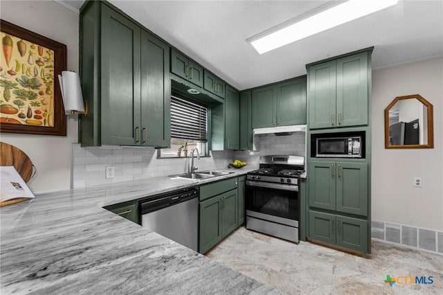 2105 S 49th St, Temple, TX 76504 - kitchen featuring green cabinets, stainless steel appliances, a sink, backsplash, and light stone countertops