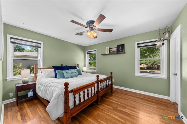 2105 S 49th St, Temple, TX 76504 - bedroom featuring multiple windows, wood finished floors, and baseboards