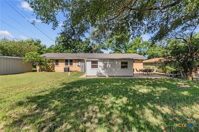 2105 S 49th St, Temple, TX 76504 - rear view of property with a lawn, a patio area, and central AC