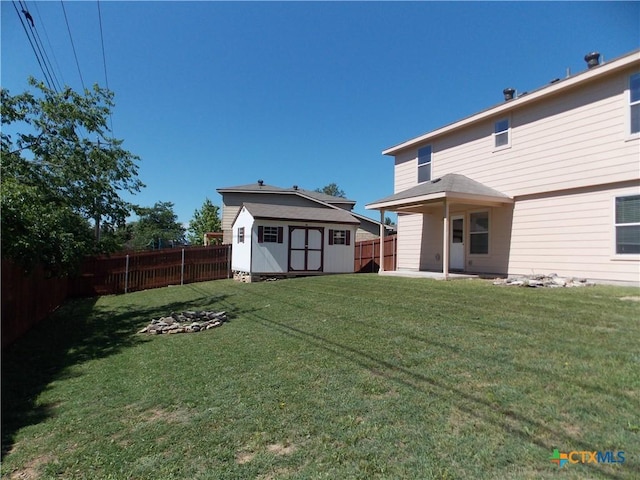 513 Pumpkin Dr, Temple, TX 76502 - back of property featuring a fenced backyard, a storage shed, and a patio area