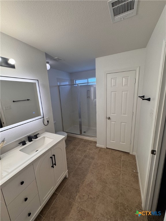513 Pumpkin Dr, Temple, TX 76502 - bathroom featuring vanity, a shower stall, a textured ceiling, and tile patterned floors