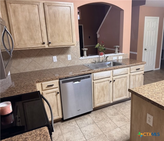 513 Pumpkin Dr, Temple, TX 76502 - kitchen featuring stainless steel dishwasher, range, arched walkways, light brown cabinetry, and decorative backsplash