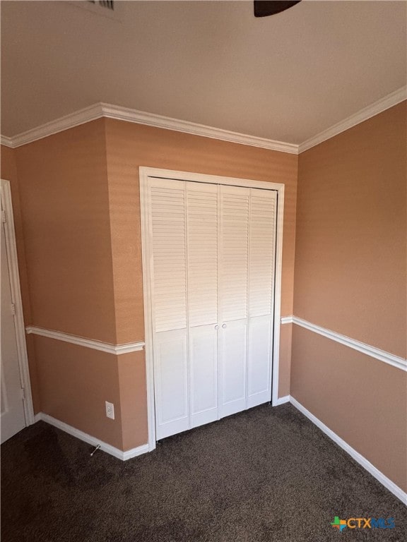 513 Pumpkin Dr, Temple, TX 76502 - unfurnished bedroom featuring dark colored carpet, ornamental molding, and a closet