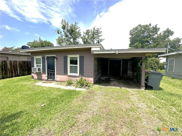 3703 Billy Dr, Victoria, TX 77901 - back of house with cooling unit, an attached carport, and driveway