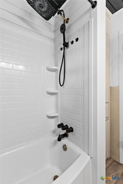 bathroom featuring hardwood / wood-style floors and tiled shower / bath