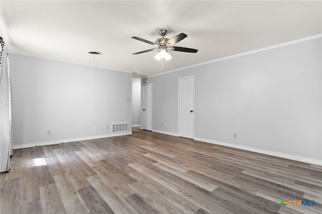 unfurnished room with light hardwood / wood-style flooring, ceiling fan, and crown molding