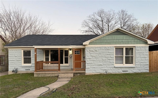 view of front facade with covered porch and a front yard