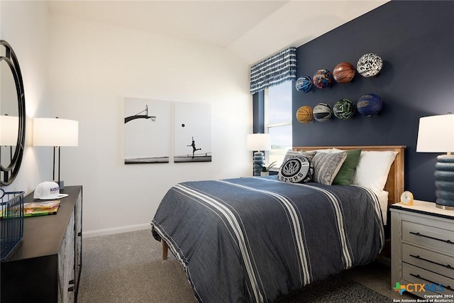 bedroom featuring vaulted ceiling and dark colored carpet