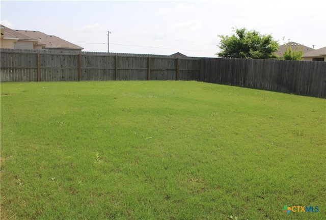view of yard with a fenced backyard