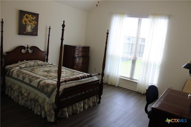 bedroom featuring wood finished floors and baseboards