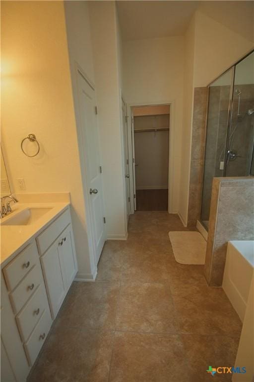 6108 Worthing Dr, Temple, TX 76502 - bathroom with a stall shower, a garden tub, vanity, and a walk in closet