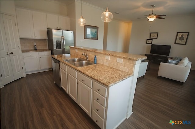 6108 Worthing Dr, Temple, TX 76502 - kitchen featuring stainless steel appliances, a sink, open floor plan, dark wood-type flooring, and ornamental molding