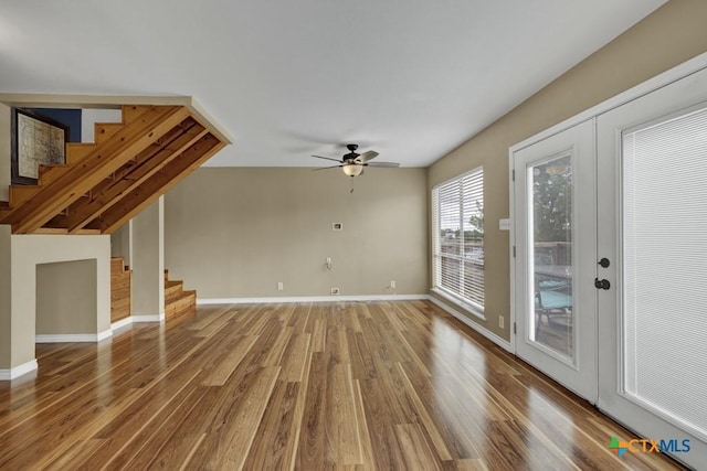 1568 Blueridge Dr, Canyon Lake, TX 78133 - unfurnished living room featuring stairway, wood finished floors, and a ceiling fan