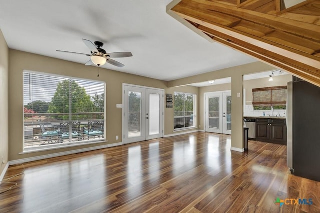 1568 Blueridge Dr, Canyon Lake, TX 78133 - unfurnished living room with french doors, a ceiling fan, healthy amount of natural light, and dark wood finished floors