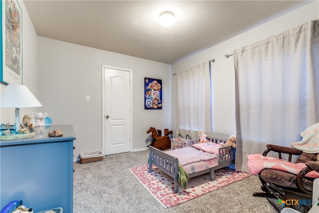 carpeted bedroom featuring a textured ceiling