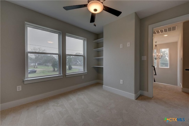 701 S Hudson St, Flatonia, TX 78941 - carpeted spare room featuring a chandelier, baseboards, and a ceiling fan