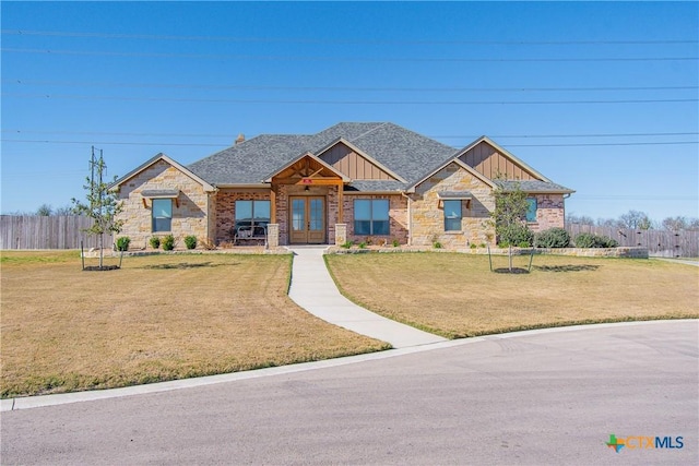 craftsman inspired home featuring a front lawn