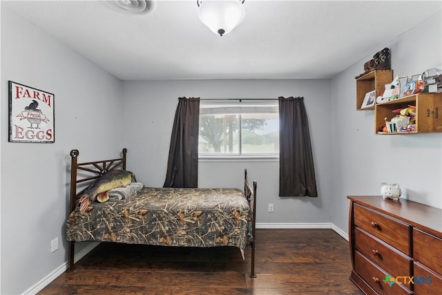 bedroom featuring baseboards and dark wood-style floors