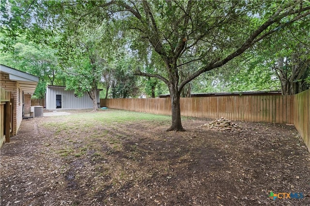 view of yard featuring a fenced backyard and central AC unit