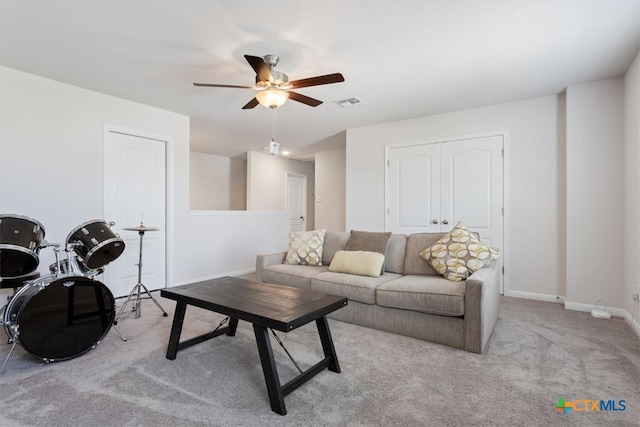 carpeted living room with ceiling fan