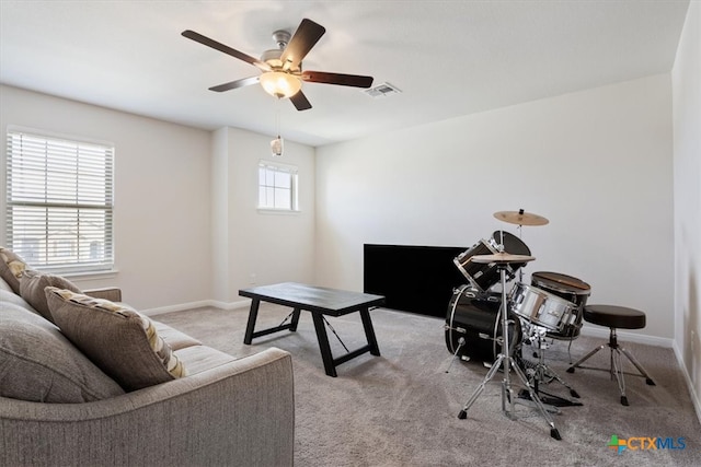 living room with light colored carpet and ceiling fan