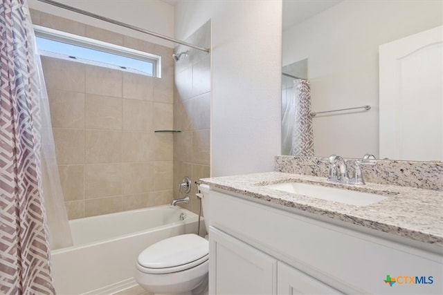 full bathroom with vanity, shower / bath combo, and toilet