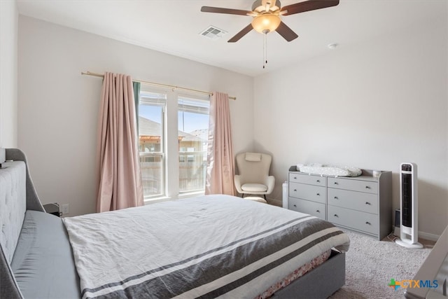 bedroom with ceiling fan and light colored carpet