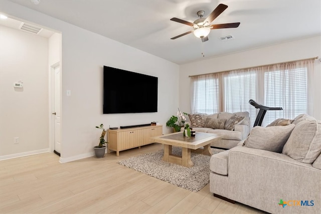 living room featuring ceiling fan and light hardwood / wood-style floors