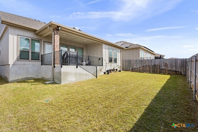 rear view of house with a lawn