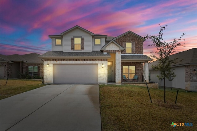 view of front of property featuring a lawn and a garage