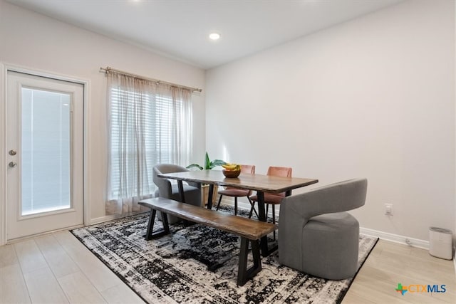 dining space with light hardwood / wood-style flooring