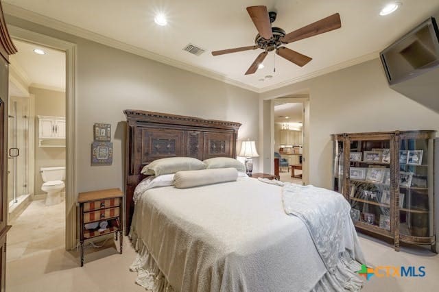 bedroom featuring ceiling fan, connected bathroom, and ornamental molding