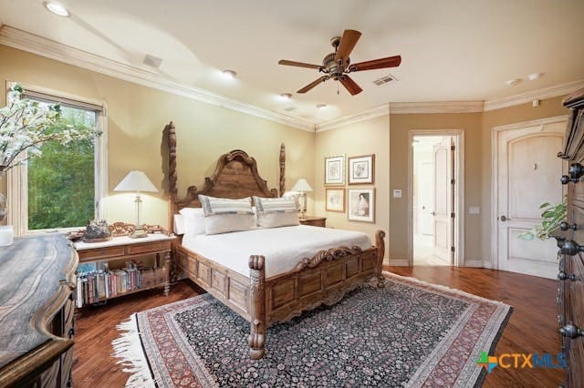 bedroom with dark hardwood / wood-style flooring, ceiling fan, and crown molding