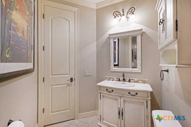 bathroom featuring vanity and ornamental molding