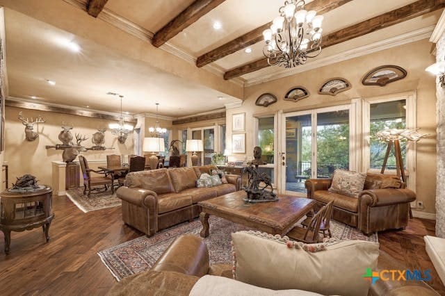 living room with ornamental molding, dark hardwood / wood-style flooring, beamed ceiling, and a chandelier