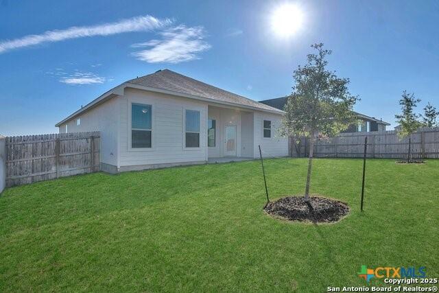 rear view of property with a lawn