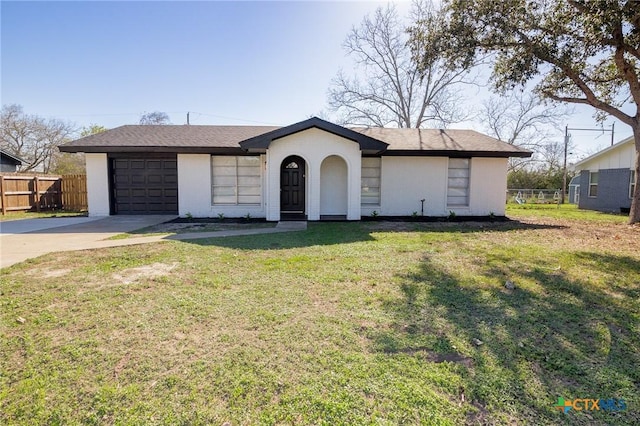 ranch-style house featuring a garage and a front lawn