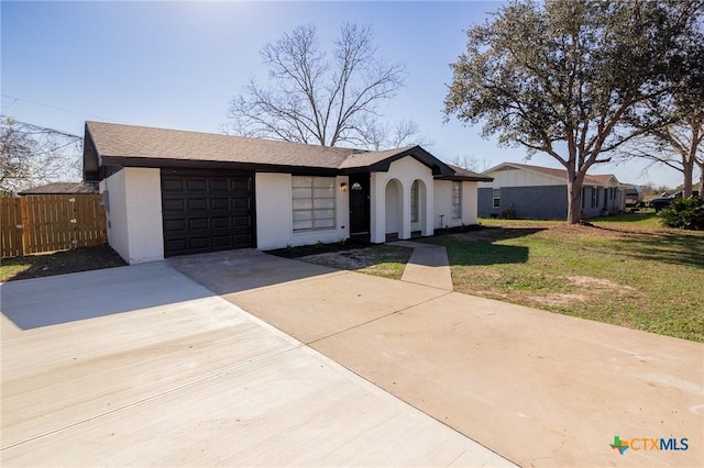 ranch-style house with a garage and a front lawn