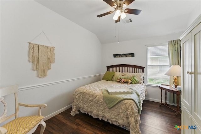 bedroom with wood finished floors, vaulted ceiling, baseboards, and a ceiling fan