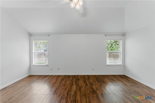 spare room with wood finished floors, ceiling fan, baseboards, and lofted ceiling