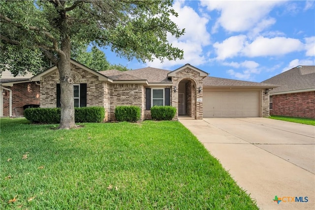 2811 Phoenix Dr, Killeen, TX 76543 - single story home featuring a garage, driveway, a front lawn, and brick siding