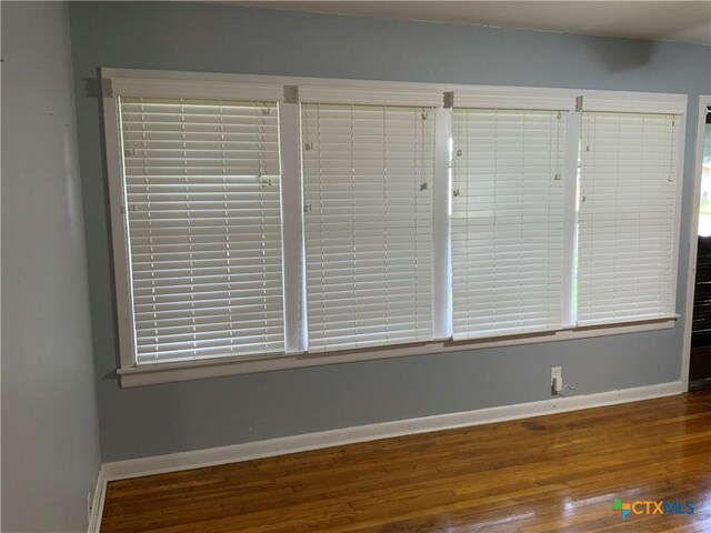 1705 E Poplar Ave, Victoria, TX 77901 - unfurnished room featuring wood finished floors and baseboards
