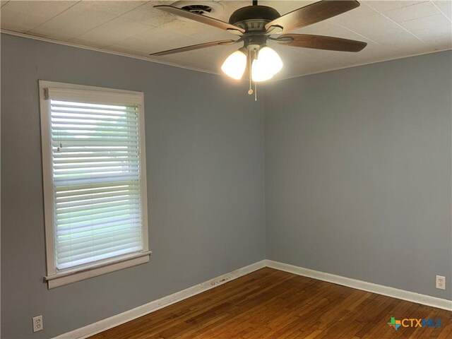 1705 E Poplar Ave, Victoria, TX 77901 - spare room with a ceiling fan, baseboards, wood finished floors, and ornamental molding