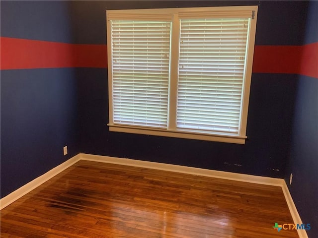 1705 E Poplar Ave, Victoria, TX 77901 - spare room featuring wood finished floors and baseboards