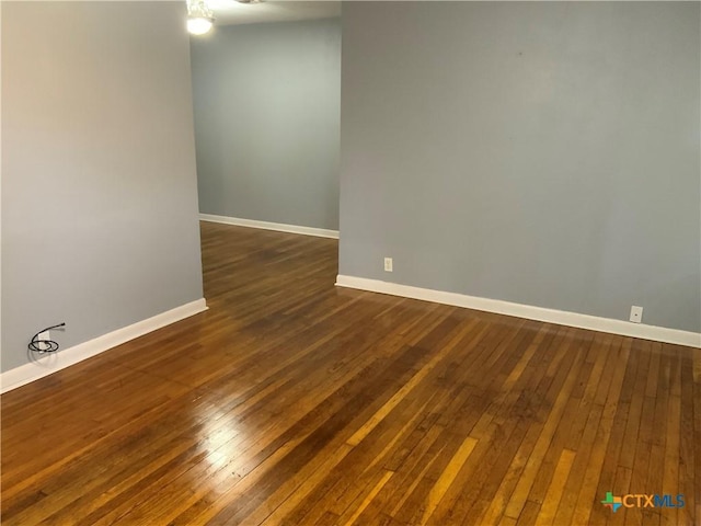 1705 E Poplar Ave, Victoria, TX 77901 - unfurnished room featuring dark wood-style flooring and baseboards