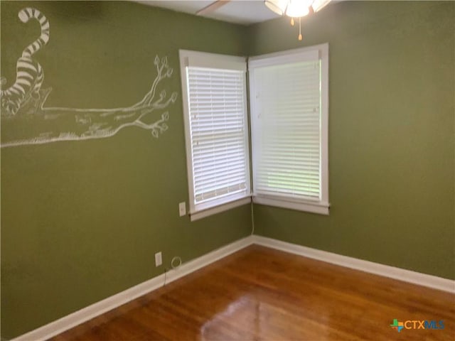 1705 E Poplar Ave, Victoria, TX 77901 - unfurnished room featuring wood finished floors, a ceiling fan, and baseboards